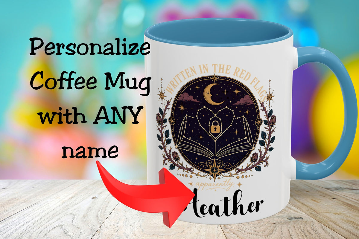 A white coffee mug with a blue handle and interior, featuring a dark celestial graphic of an open book, crescent moon, stars, and the text 'Written in the Red Light' and 'apparently Leather'. Large text on the left reads 'Personalize Coffee Mug with ANY name' with a red arrow pointing to the mug.