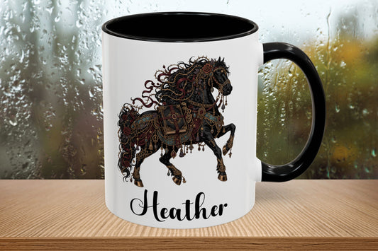 A white ceramic mug with a black handle and black interior, featuring a detailed black and brown illustration of a rearing horse and the name 'Heather' in black script near the bottom. The mug is shown on a wooden surface with a blurred rainy window background.