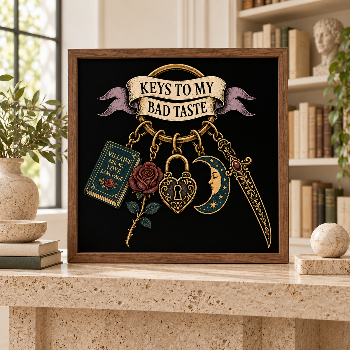 A framed gothic-themed art print on a stone shelf in a cozy room. The print features a black background with a wooden frame, a banner reading 'KEYS TO MY BAD TASTE', and illustrations of a rose, padlock, dagger, and a book labeled 'VILLAINS ARE LOVE LANGUAGES'.