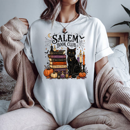 Calling all spooky readers! 🖤📚 The Salem Book Club shirt is the perfect Halloween tee for book lovers who can't resist black cats, witchy vibes, candlelit reading nights, and magical stories. Featuring a charming black cat, vintage spell books, pumpkins, potion bottles, spider webs, bats, and cozy autumn details, this Comfort Colors shirt is made for BookTok fans, book club meetings, bookstore visits, Halloween parties, and all your fall adventures. A fun gift for readers, librarians, teachers, fantasy lo
