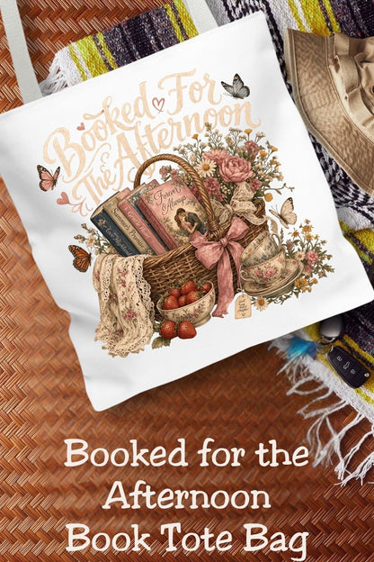 Your afternoon is officially reserved for books. 📚🩷 The Booked for the Afternoon tote bag is the perfect accessory for romance readers, BookTok fans, and cottagecore lovers. Featuring a charming wicker basket filled with romance novels, vintage teacups, strawberries, wildflowers, butterflies, and a soft pink bow, this spacious tote is perfect for bookstore trips, library hauls, reading picnics, coffee shop dates, and everyday errands. A thoughtful gift for book lovers, librarians, teachers, book club frie