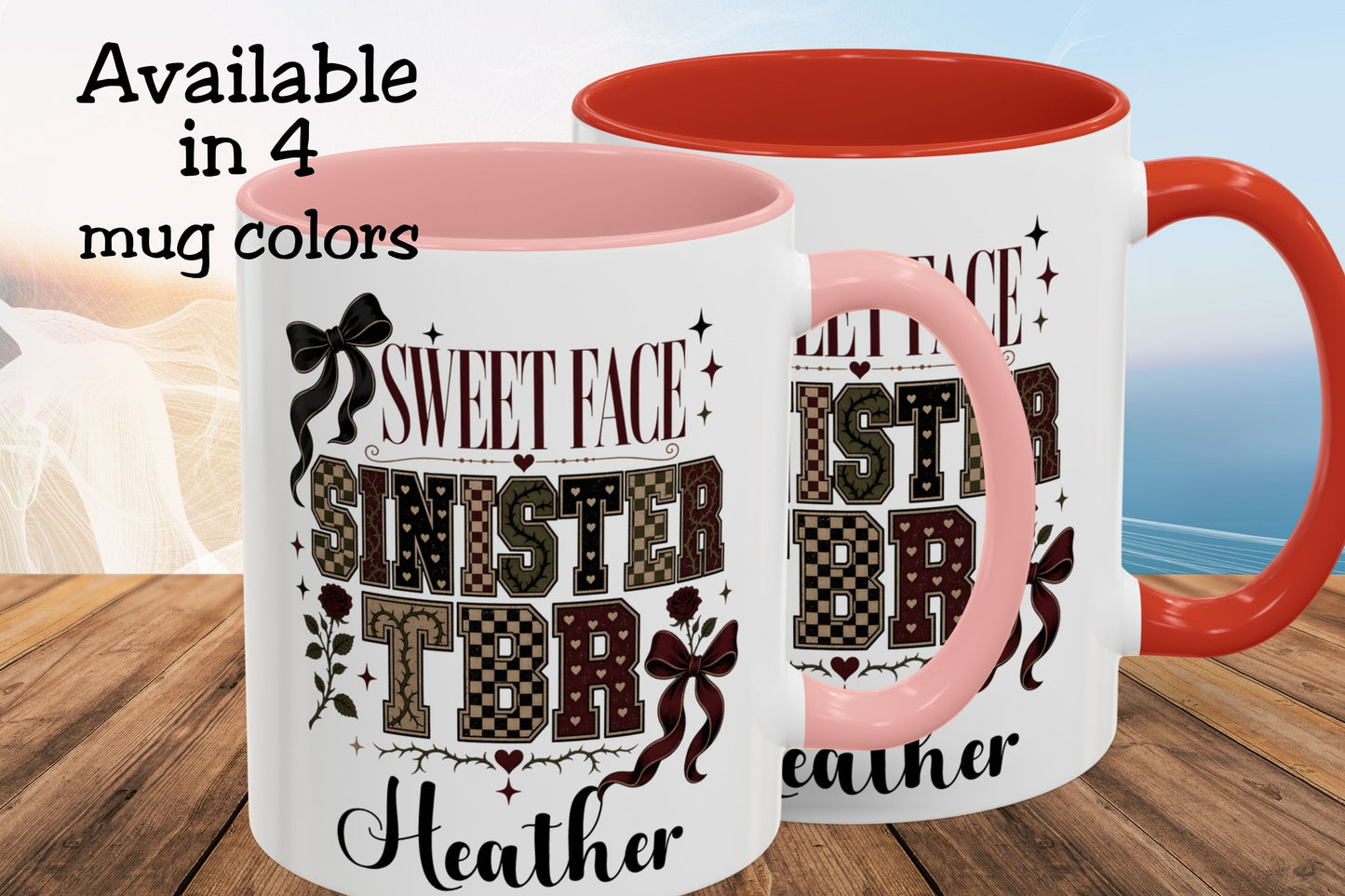 Two ceramic mugs shown on a wooden surface with a blurred beach background. The mugs are white with pink interiors and handles, featuring a dark brown and black patterned design that reads 'Sweet Face Sinister Brother' with the name 'Heather' at the bottom.