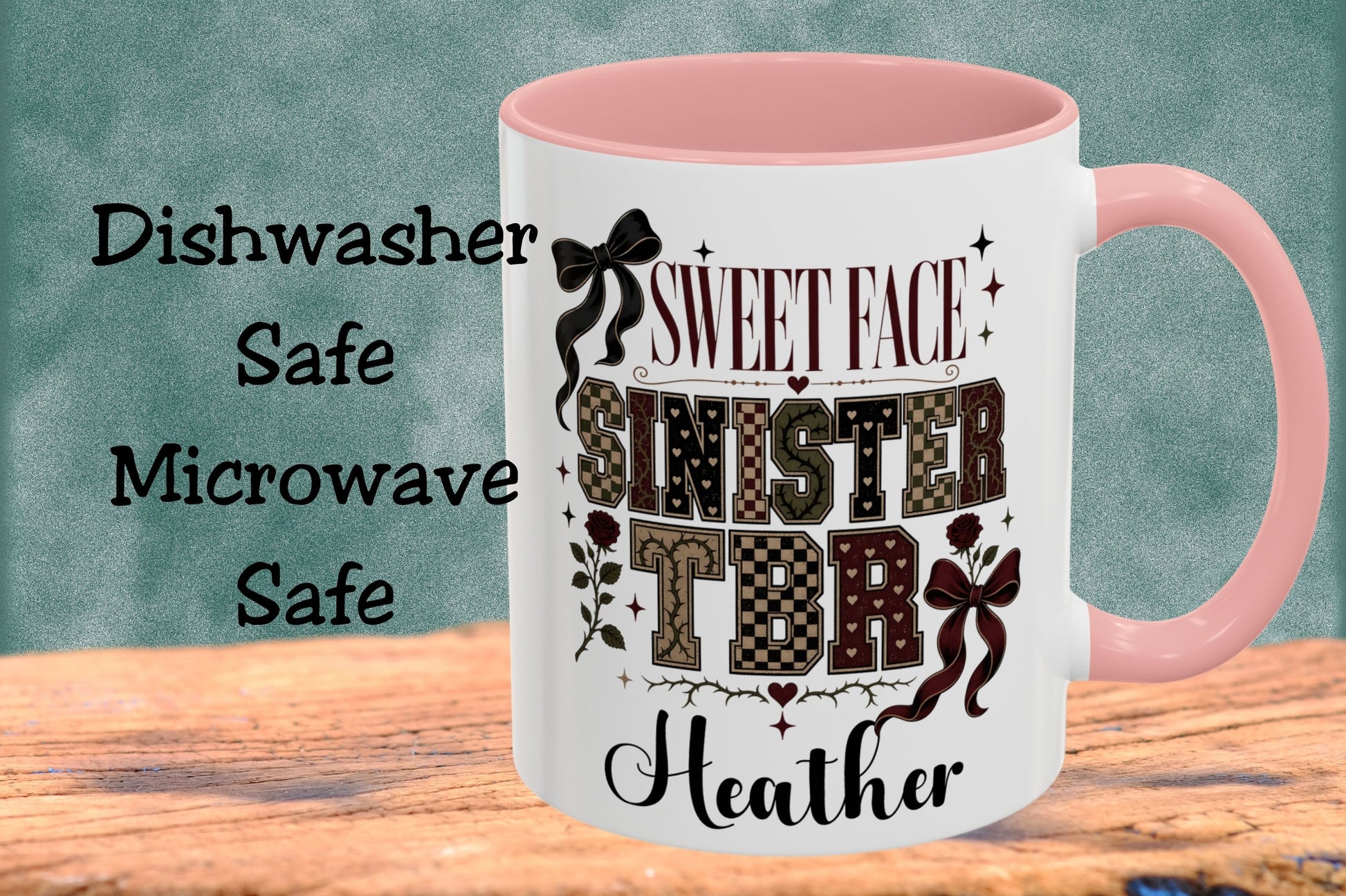 A white ceramic mug with a pink interior and handle, featuring a custom printed design that reads 'SWEET FACE SINISTER TITHE Heather' with decorative bows and patterned lettering. The mug is displayed on a wooden surface against a textured teal background, with text on the left stating 'Dishwasher Safe Microwave Safe'.