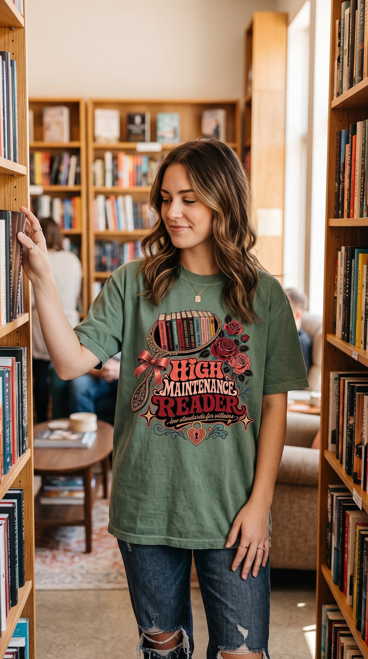 Cozy reading days call for the perfect bookish tee. 📚🌹 This High Maintenance Reader shirt features a vintage romance-inspired design with stacked books, roses, bows, and the playful phrase “Low Standards for Villains.” A fun gift for romance readers, dark romance fans, BookTok lovers, book club friends, and anyone who proudly falls for fictional red flags. Pair it with jeans or leggings for your next bookstore trip, library day, or cozy reading weekend.

#BookLoverShirt #RomanceReader #BookishShirt #BookT