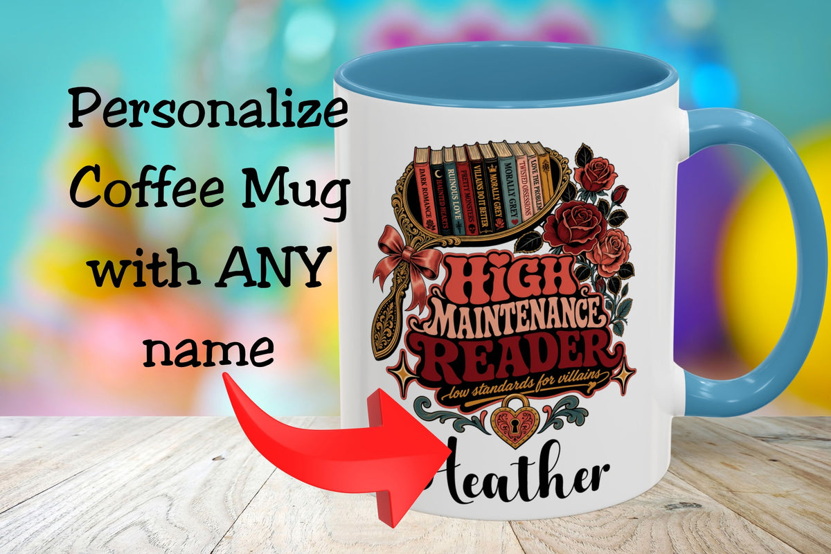 A white ceramic coffee mug with a blue handle and interior, featuring a decorative graphic of books, roses, and the text 'HIGH MAINTENANCE READER' with 'Leather' printed below. Large overlaid text says 'Personalize Coffee Mug with ANY name' with a red arrow pointing to the mug.