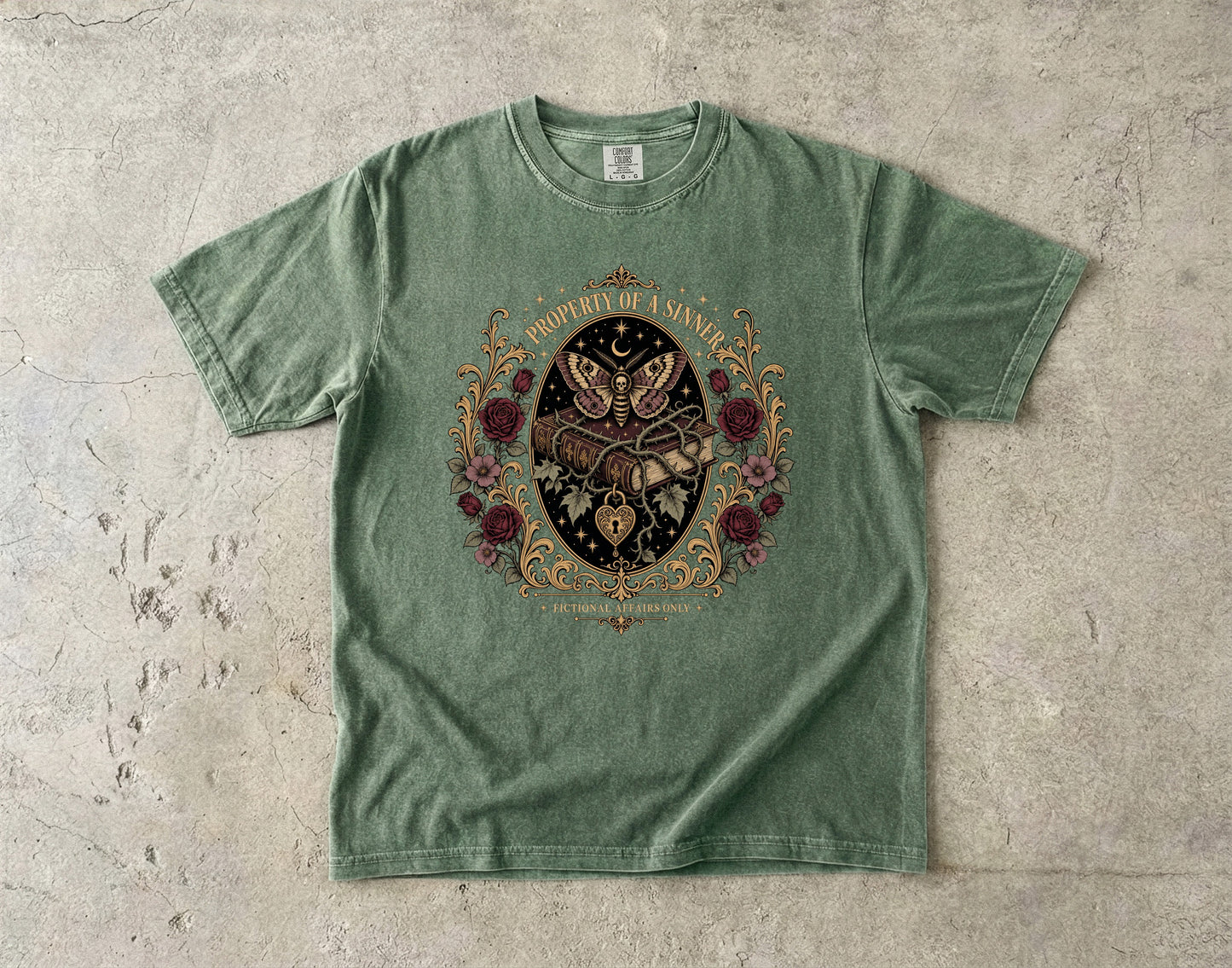 A sage green short-sleeve t-shirt with a detailed gothic graphic of a skeleton hand holding a dagger, surrounded by a butterfly, roses, and the text 'PROPERLY UNARMED' on a textured concrete background.