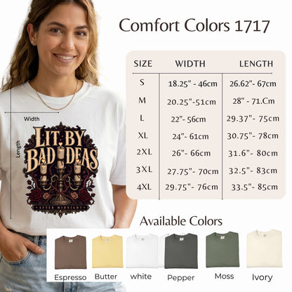 A woman models a white graphic T-shirt with a dark vintage-style print reading 'Lit. by Bad Ideas' and 'Proudly American.