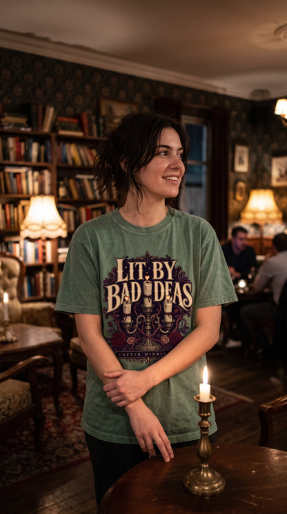 Made for readers whose best fictional decisions happen after midnight. This gothic book lover shirt features an ornate candlelit candelabra, burgundy roses, thorny vines, Victorian details, and the phrase “Lit By Bad Ideas, After Midnight.” A moody gift idea for dark romance readers, midnight bookworms, romantasy fans, and lovers of fictional red flags. #GothicBookish #DarkRomanceReader #BookTokStyle #ReaderGift #DarkAcademia