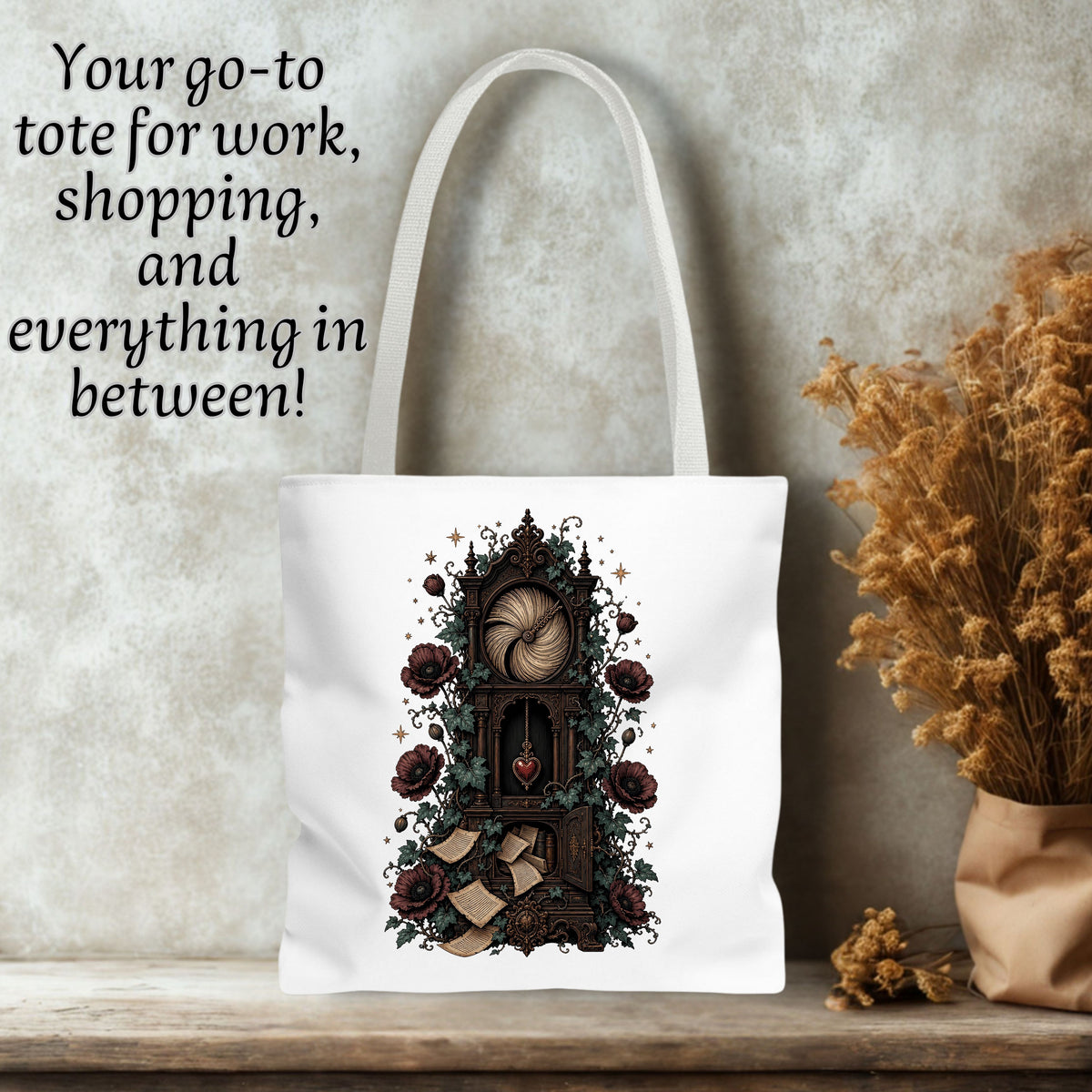 White canvas tote bag with a gothic illustration of a clockwork mechanism, roses, and a heart, displayed on a wooden surface against a textured gray wall with dried flowers and text overlay.