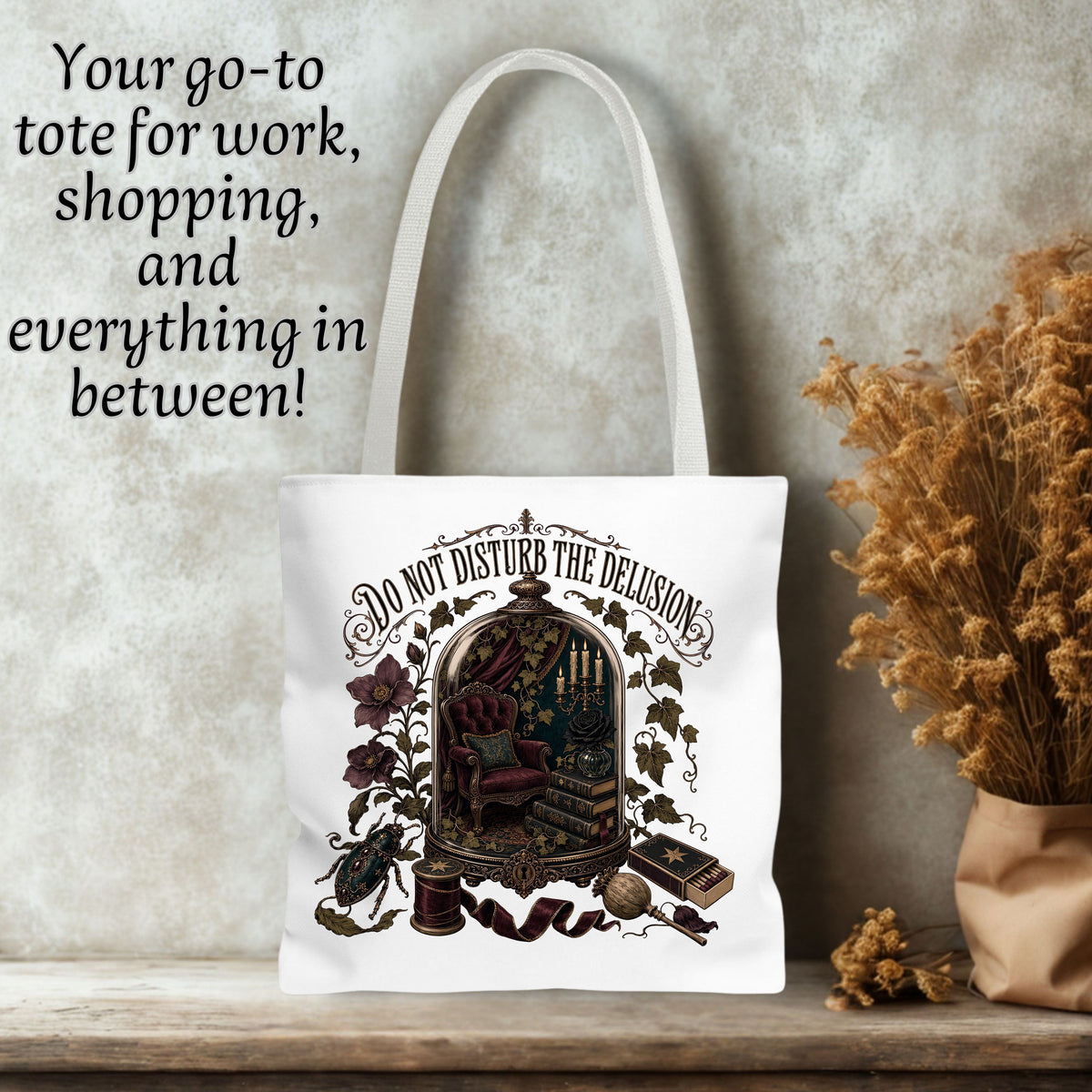 A white canvas tote bag with a whimsical vintage illustration of a rabbit in a cage and the text 'DO NOT DISTURB THE DELUSION' displayed on a rustic shelf next to dried flowers, with promotional text overlay on the left.