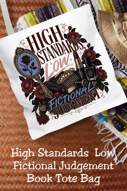 High standards in real life, questionable taste in fictional characters. This funny romance reader tote features an ornate mirror, books, lipstick, and burgundy flowers with vintage gothic details. The 16 × 16-inch book bag carries your current read and everyday essentials for library trips, bookstore browsing, and book club nights. A thoughtful gift for dark romance readers, romantasy fans, and friends who always defend the villain.