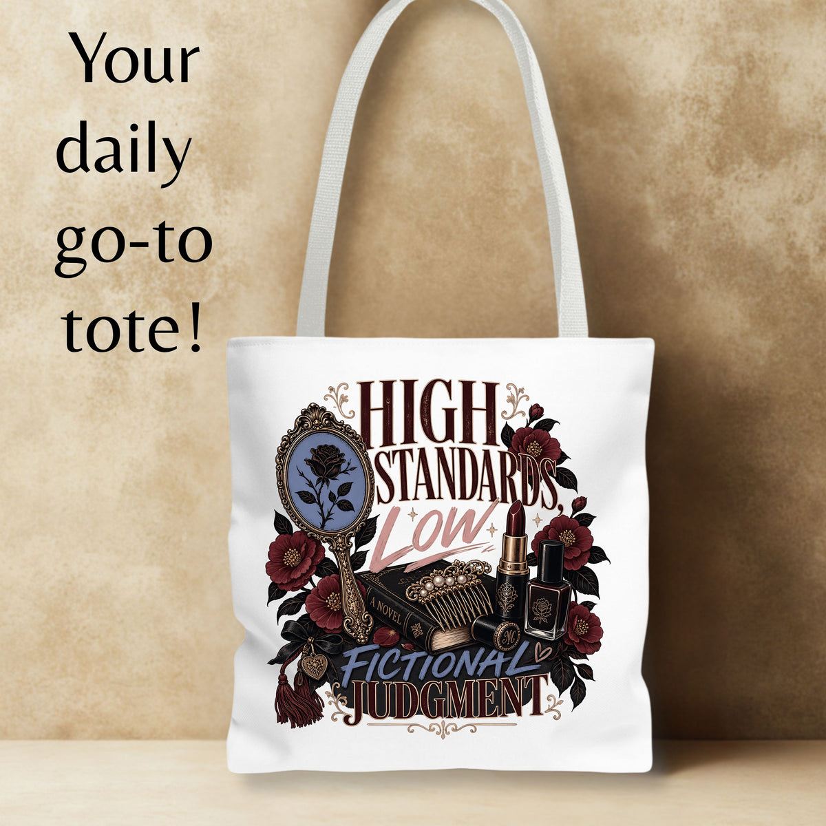 A white canvas tote bag with a gothic-themed graphic print featuring the text 'HIGH STANDARDS LOW! FICTIONAL JUDGMENT' and illustrations of a mirror, roses, and lipstick. The bag is displayed against a textured beige background with promotional text on the left.