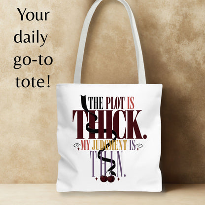 A white canvas tote bag with white shoulder straps, featuring a printed quote from The Powerpuff Girls: 'THE PLOT IS THICK. MY JUDGMENT IS THIN.