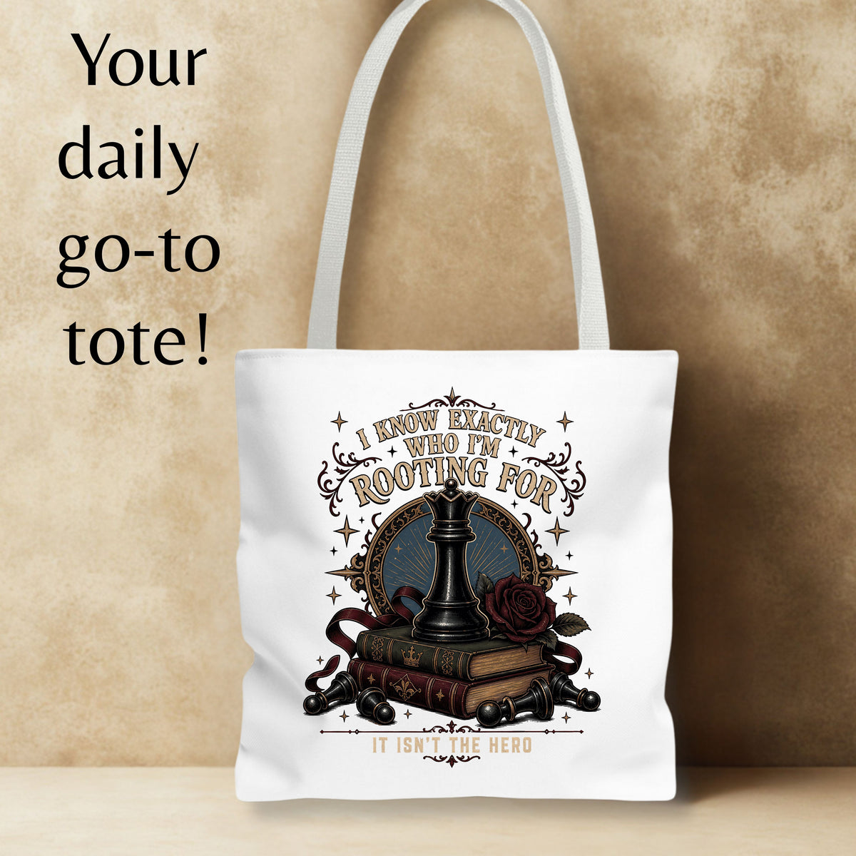A white canvas tote bag with a dark fantasy-themed graphic print featuring a chess piece, books, a rose, and decorative text, displayed against a textured beige background with promotional text on the left.
