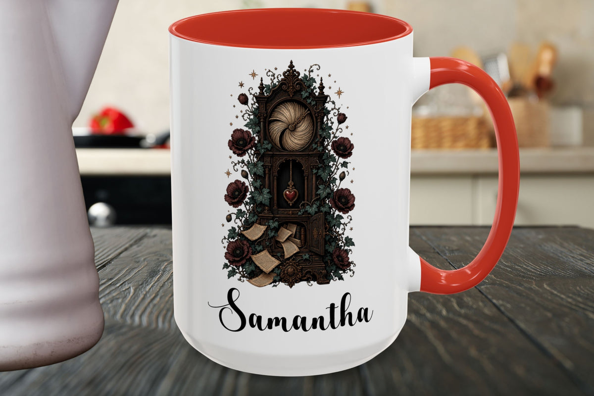 A white ceramic mug with a red handle and interior, featuring a dark gothic illustration of a grandfather clock surrounded by roses and the name 'Samantha' in black script at the bottom. The mug is shown on a dark wooden table with a blurred kitchen background.