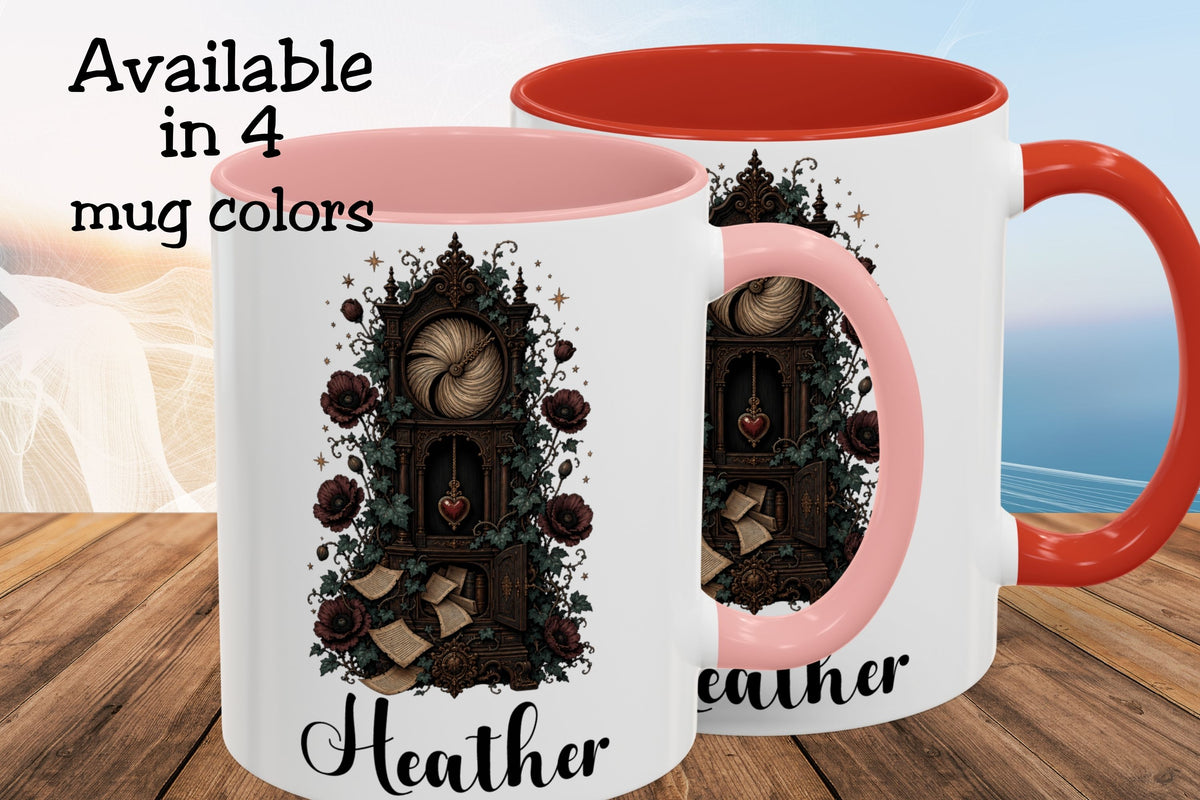 Two white ceramic mugs with pink and orange-red interiors and handles, shown on a wooden surface with a blurred beach background. The mugs feature a dark gothic illustration of a clockwork mechanism with roses and the name 'Heather' printed below.