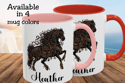 Two white ceramic mugs with pink interiors and handles are shown on a wooden surface with a blurred beach background. The mugs feature a decorative black and brown horse illustration and the name 'Heather' printed below.