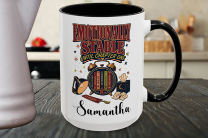 A white ceramic mug with a black handle and interior, featuring a colorful graphic that reads 'Emotionally Stable Until Chapter One' and the name 'Samantha' on a dark wooden tabletop.