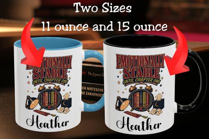 Two printed ceramic mugs shown side by side with text reading 'Two Sizes 11 ounce and 15 ounce' and red arrows pointing to each mug. The mugs are white with a blue interior on the left and a black interior on the right, both printed with a decorative book-themed graphic and the name 'Heather'.