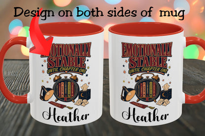 Two white ceramic mugs with red interiors and handles are shown side by side on a dark wooden surface with colorful blurred lights in the background. Text at the top says 'Design on both sides of mug' with an arrow pointing to the left mug.