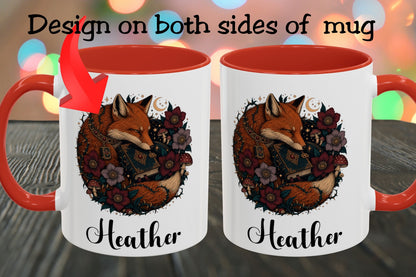 A white ceramic mug with a red handle and red interior, shown twice side by side to demonstrate design placement on both sides. The front design features an illustrated fox surrounded by flowers and the name 'Heather' in script.