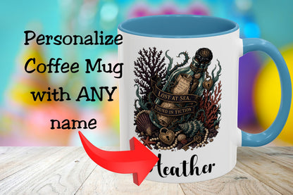 A white coffee mug with a blue handle and interior, featuring an underwater bottle illustration with the words 'Lost at Sea, Found in Fiction.' The mug is shown on a wooden surface with promotional text reading 'Personalize Coffee Mug with ANY name' and a red arrow pointing to the printed name 'Leather.
