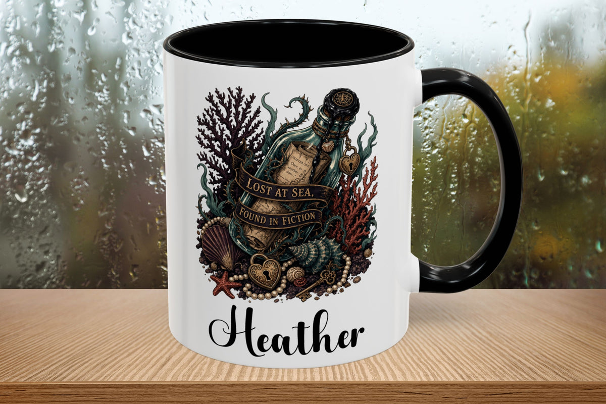 A white ceramic mug with a black handle and black interior, featuring an underwater illustration of a bottle, shells, coral, and the text 'LOST AT SEA. SOUNDS IN FICTION.