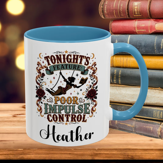 A white ceramic mug with a blue handle and interior, featuring a vintage-style graphic that reads 'TONIGHT'S FEATURE POOR IMPULSE CONTROL Heather' with a swing girl illustration. The mug sits on a wooden surface with a stack of old books in a blurred background.