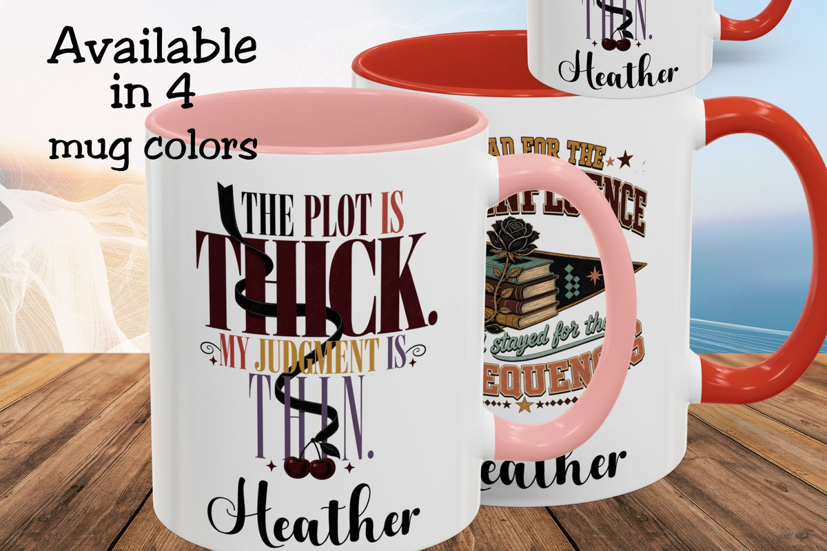 Three ceramic mugs shown on a wooden surface with a blurred beach background. The mugs are white with pink interiors and handles, and one mug has a red handle.
