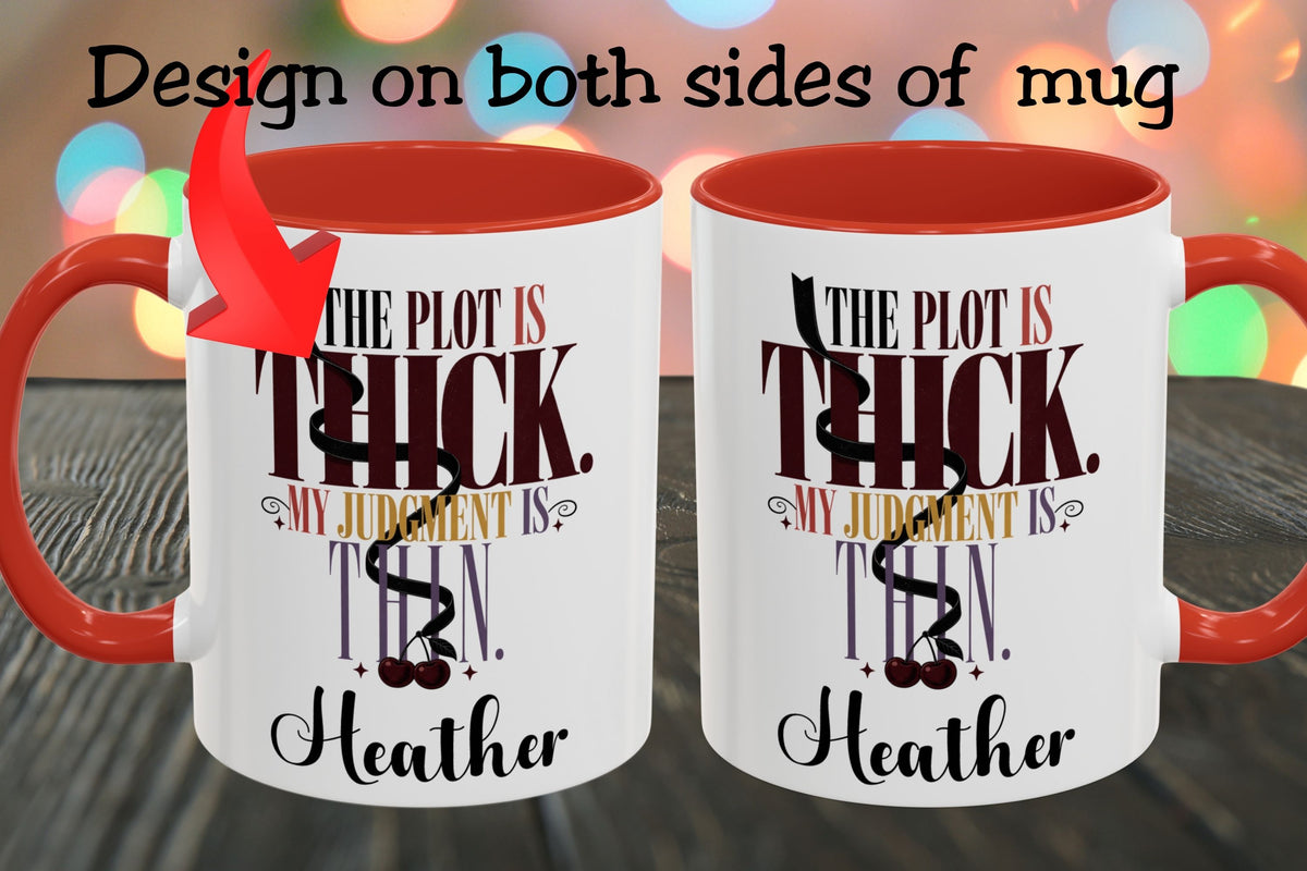 Two white ceramic mugs with red interiors and red handles are shown on a dark wooden surface with colorful blurred lights in the background. Text at the top says 'Design on both sides of mug' with an arrow pointing to the left mug.
