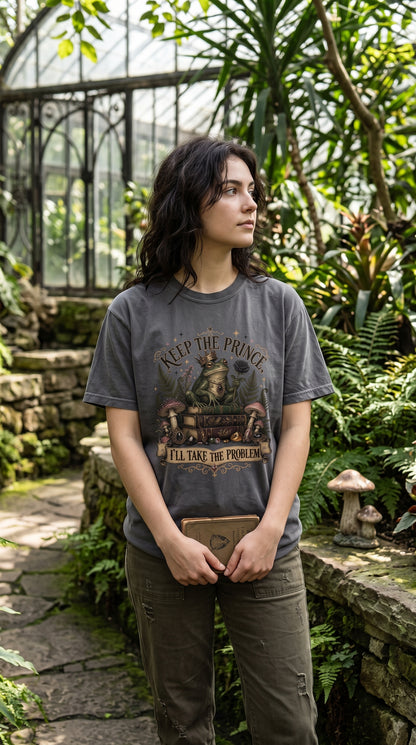 Keep the prince—I’ll take the problem. This funny romantasy book lover shirt features a crowned frog, black rose, antique books, mushrooms, ferns, and gothic storybook details. Available in Blue Jean, Moss, Pepper, Butter, Espresso, Ivory, and White, it makes a fun gift for fantasy readers, dark romance fans, book club friends, and anyone who always chooses the complicated character.
