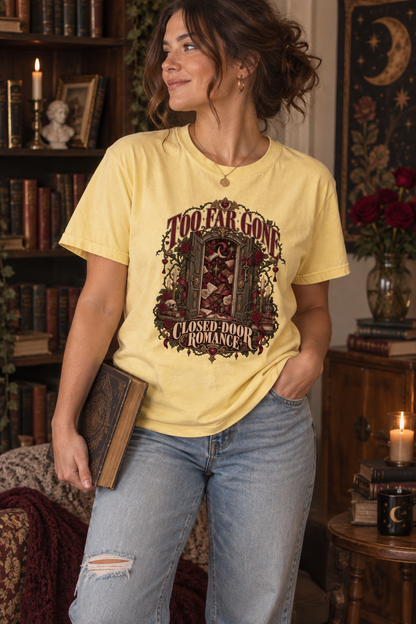 Too far gone—and happily staying there. This gothic “Too Far Gone, Closed-Door Romance” shirt features an ornate doorway surrounded by burgundy roses, antique books, candles, keys, and dark-academia details. A thoughtful gift for closed-door romance readers, sweet-romance fans, book club friends, librarians, and gothic book lovers. Available on a soft Comfort Colors tee for cozy reading days, bookstore visits, and book club nights. #BookLoverShirt #ClosedDoorRomance #BookishGift