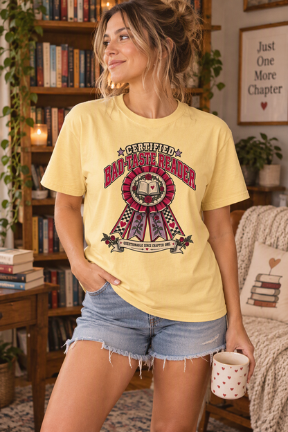 Shop the “Certified Bad-Taste Reader” shirt for the romance reader who proudly loves fictional red flags and questionable characters. Featuring a vintage award ribbon, open book, red roses, hearts, and checkerboard details, this funny bookish tee is perfect for book club, bookstore trips, reading retreats, and author events. A fun birthday or holiday gift for book lovers, romance readers, book besties, librarians, and romantasy fans.
