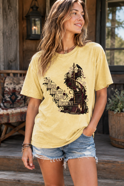 Here for the slow descent—and every agonizing chapter along the way. This gothic book lover shirt features an antique spiral staircase surrounded by stacked books, burgundy roses, floating pages, and warm candlelight. A unique gift for slow-burn romance readers, dark romance fans, romantasy lovers, writers, and dark-academia bookworms. Perfect for book clubs, bookstore trips, library visits, author events, and cozy reading weekends.
