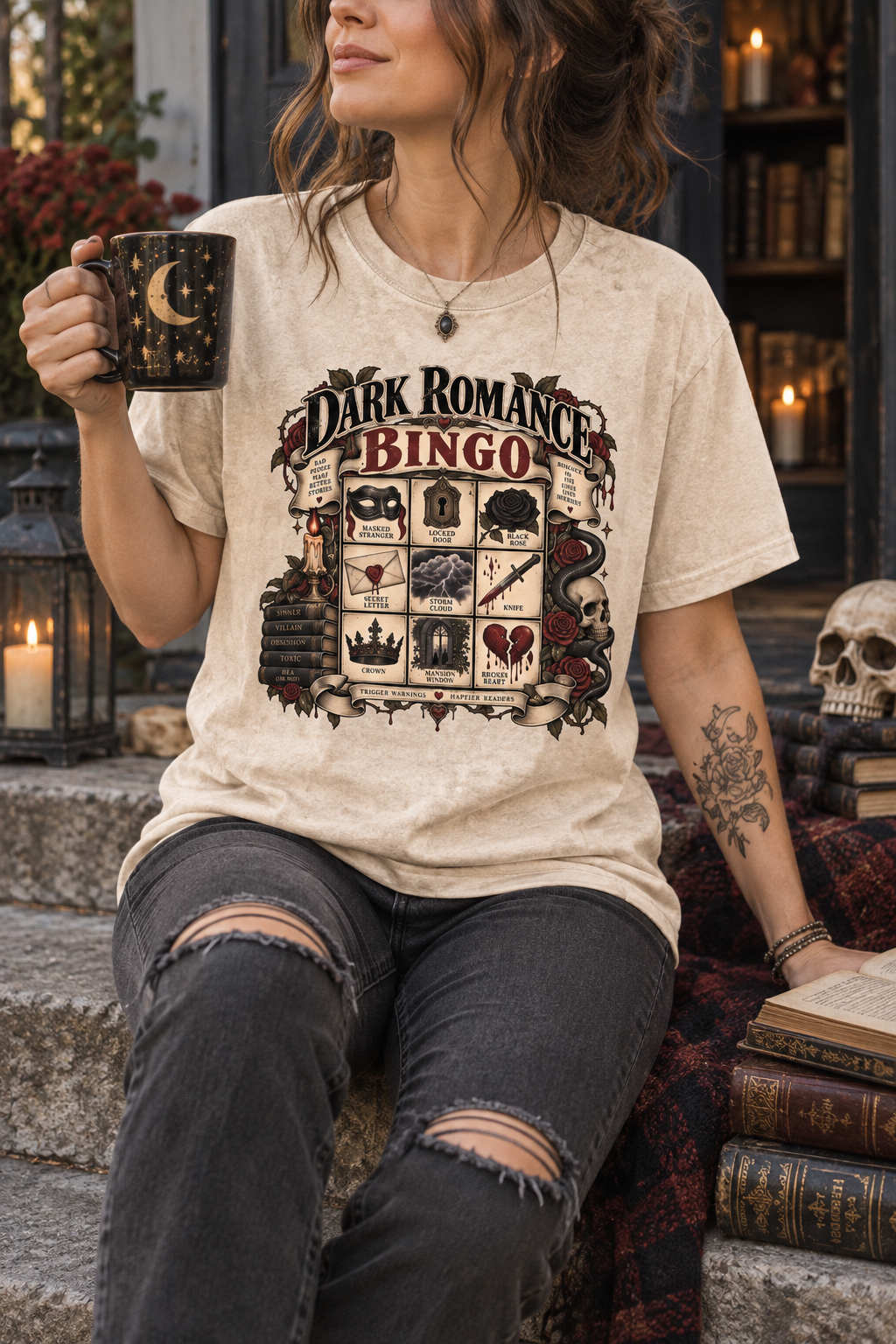 Dark romance readers, your bingo card has arrived. This gothic book-lover shirt features favorite dark romance elements including a masked stranger, locked door, black rose, secret letter, knife, crown, mysterious mansion, and broken heart. A fun book-club outfit or gift for romance readers who love morally gray characters, dangerous secrets, possessive villains, and beautifully complicated stories.