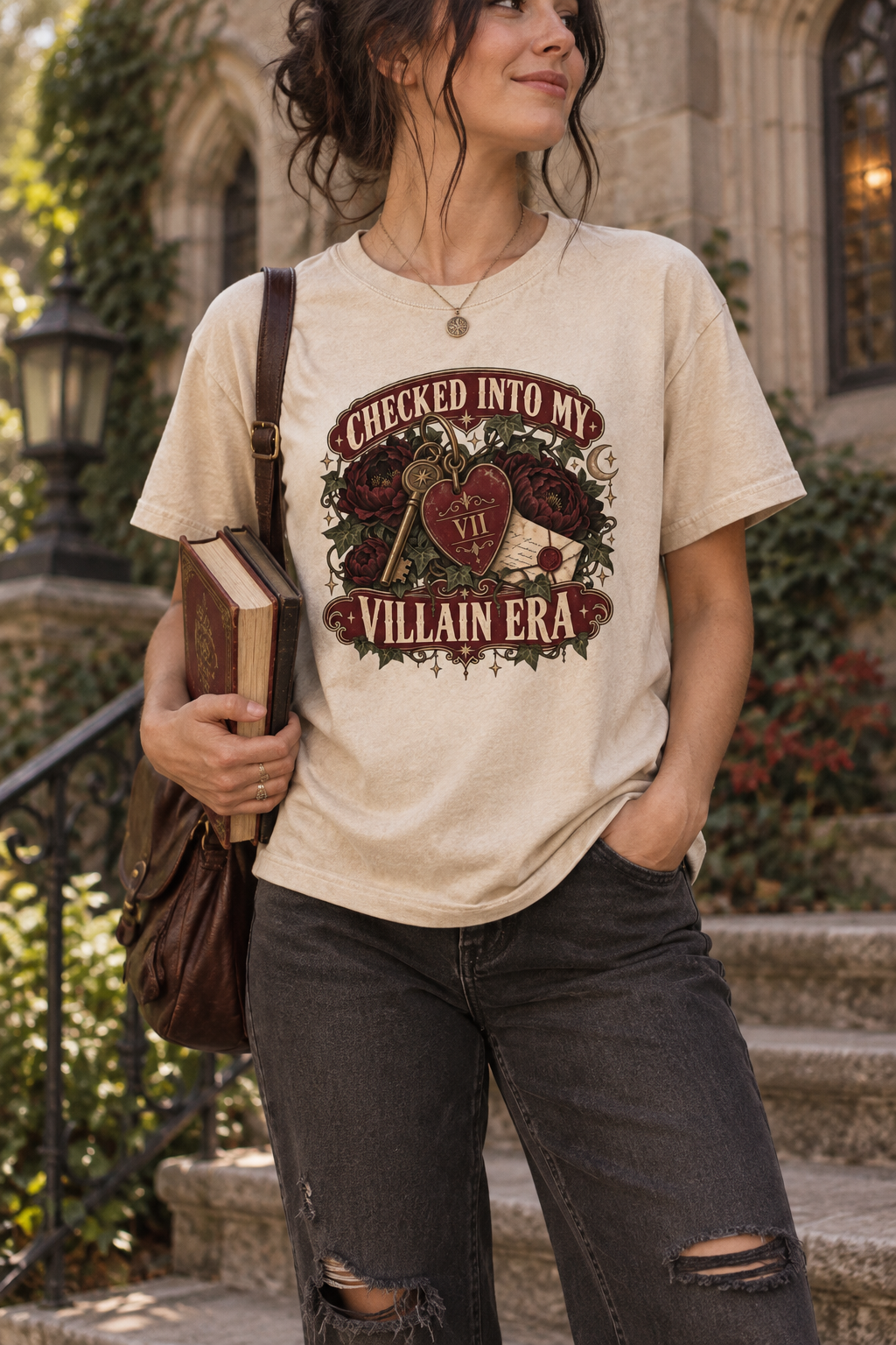 Officially checked into your villain era? This gothic book-lover shirt features distressed vintage lettering, dark burgundy flowers, trailing ivy, an antique key, heart-shaped room tag, wax-sealed letter, and celestial details. A memorable gift for dark romance readers, romantasy fans, book-club friends, and anyone who always chooses the morally gray character.