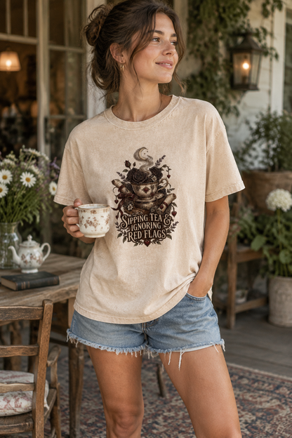 Sipping Tea & Ignoring Red Flags shirt for dark romance readers, romantasy fans, and tea-loving bookworms. This gothic book-lover tee features a vintage teacup, black roses, antique books, celestial details, and distressed lettering. A fun book-club outfit and thoughtful gift for romance readers, BookTok fans, librarians, and anyone who loves morally gray fictional men.