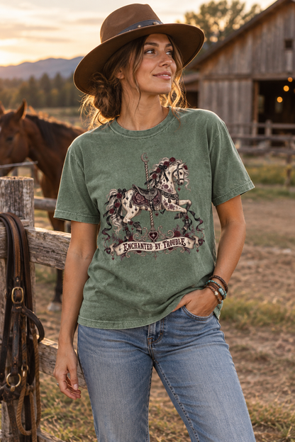 Fall for fictional danger with this “Enchanted by Trouble” Comfort Colors shirt. Featuring an ornate carousel horse decorated with burgundy roses, black ribbons, celestial details, and vintage gothic accents, this relaxed unisex tee is perfect for dark romance readers, romantasy fans, BookTok friends, and lovers of morally gray characters. A unique book lover gift for book club, bookstore trips, and cozy reading days.