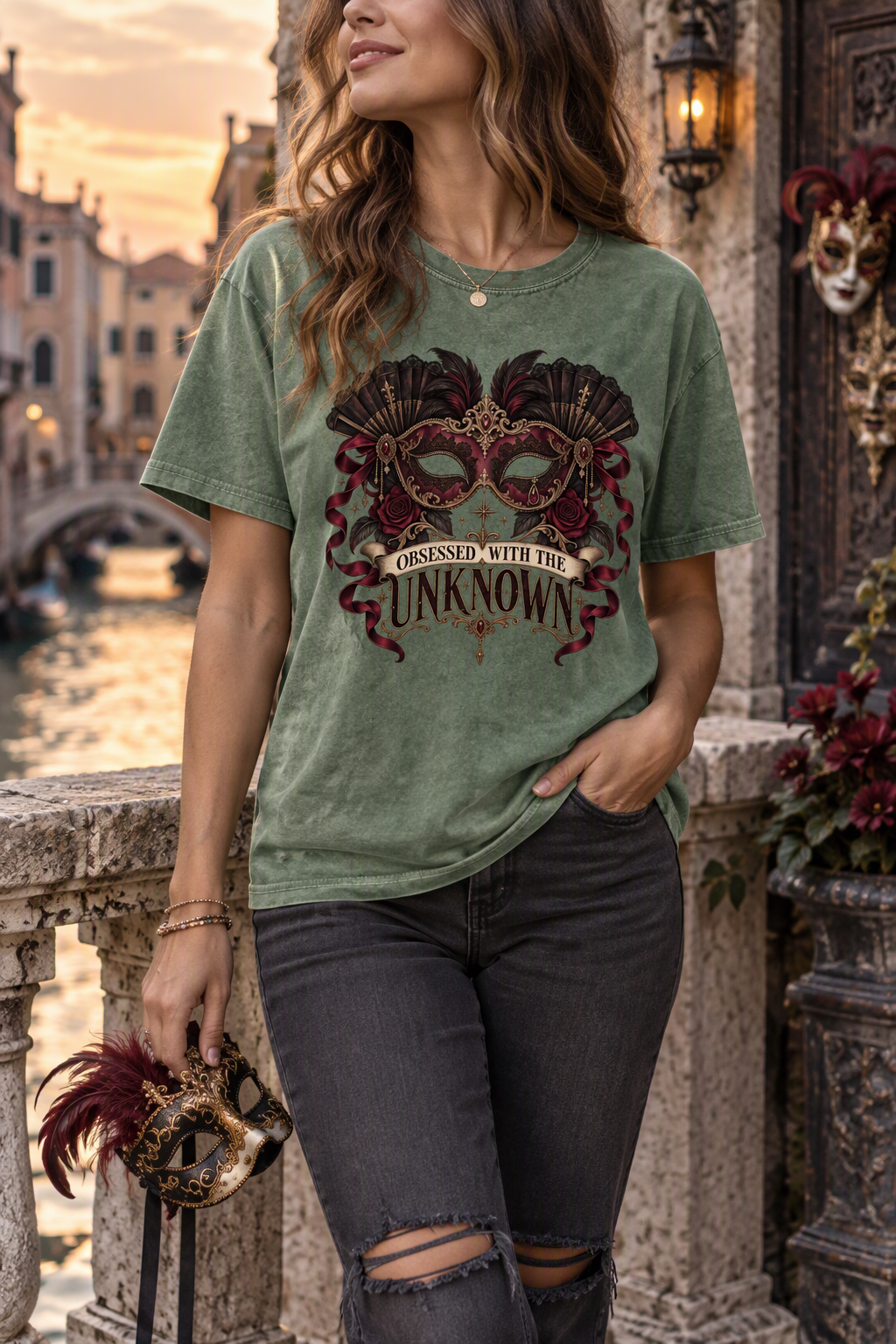 Some mysteries are too tempting to leave unsolved. This “Obsessed With the Unknown” Comfort Colors shirt features an ornate burgundy masquerade mask surrounded by black fans, feathers, roses, ribbons, ruby jewels, and antique-gold details. A dramatic gift for dark romance readers, romantasy fans, BookTok friends, and anyone drawn to masked characters, secret identities, and morally gray love interests.

#DarkRomance #BookLoverGift #BookTokStyle