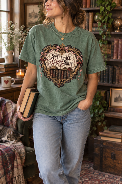 Dangerous people make better stories. This “SINFUL” Comfort Colors shirt features a burgundy motorcycle helmet wrapped in silver thorns, a black floral scarf, red roses, a broken heart, and a distressed book. Perfect for dark romance readers, biker-romance fans, morally gray character lovers, book club, bookstore trips, or gifting to the reader who never chooses the safe fictional man. #DarkRomance #BookishShirt #ReaderGift
