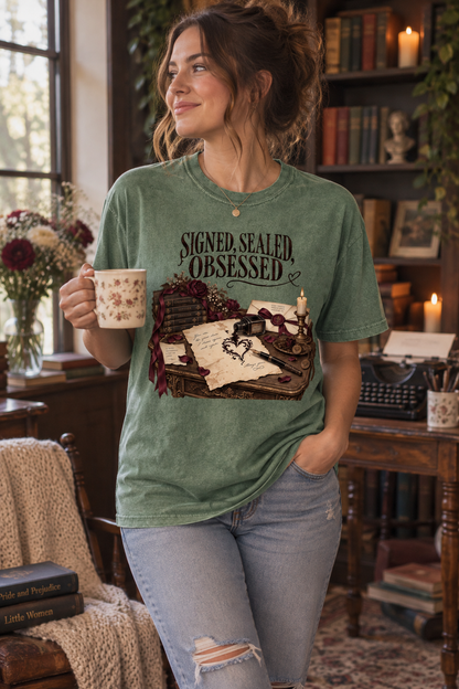 For readers who consider fictional obsession a love language. This “Signed, Sealed, Obsessed” Comfort Colors shirt features forbidden books, secret letters, burgundy flowers, wax seals, an overflowing ink bottle, a vintage pen, and candlelight. Perfect for dark romance, forbidden-love, gothic-fiction, and obsessive-hero readers—or as a memorable gift for your favorite book lover. #DarkRomance #BookishShirt #ReaderGift