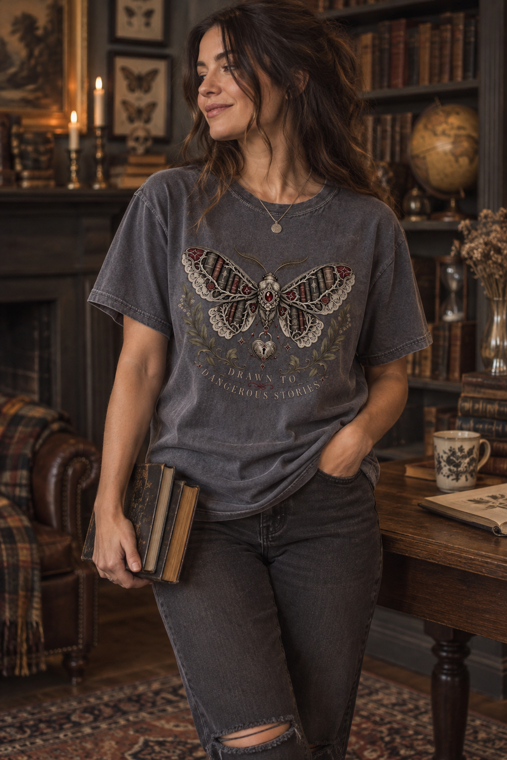 Drawn to dangerous stories—and the fictional characters who should probably come with warning labels. This gothic book lover shirt features an ornate moth with antique books woven into its wings, surrounded by lace, burgundy gemstones, roses, botanical branches, and celestial charms. The soft Comfort Colors tee has a relaxed unisex fit that is perfect for book club, bookstore trips, reading weekends, and everyday dark-academia style. A unique gift for dark romance readers, romantasy fans, BookTok followers,