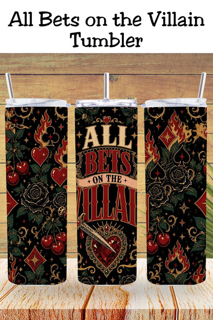 Hydration, but make it morally questionable. 🖤♥️ The All Bets on the Villain Tumbler features a bold gothic wrap with fiery card suits, black roses, cherries, ornate gold flourishes, a dagger, and a jeweled heart against a dramatic black background. Perfect for dark romance readers, romantasy fans, villain lovers, and readers who proudly choose fictional red flags. #BookLoverTumbler #DarkRomance #VillainEra #AllBetsOnTheVillain #RomantasyReader #BookTokGift #ReaderLife #BookishGift