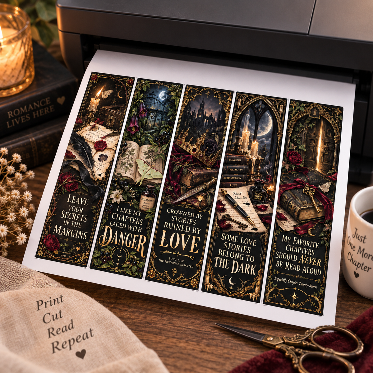 A set of five decorative book bookmarks printed with gothic fantasy illustrations and quotes, shown emerging from a printer on a styled desk with scissors, a mug, and a candle.